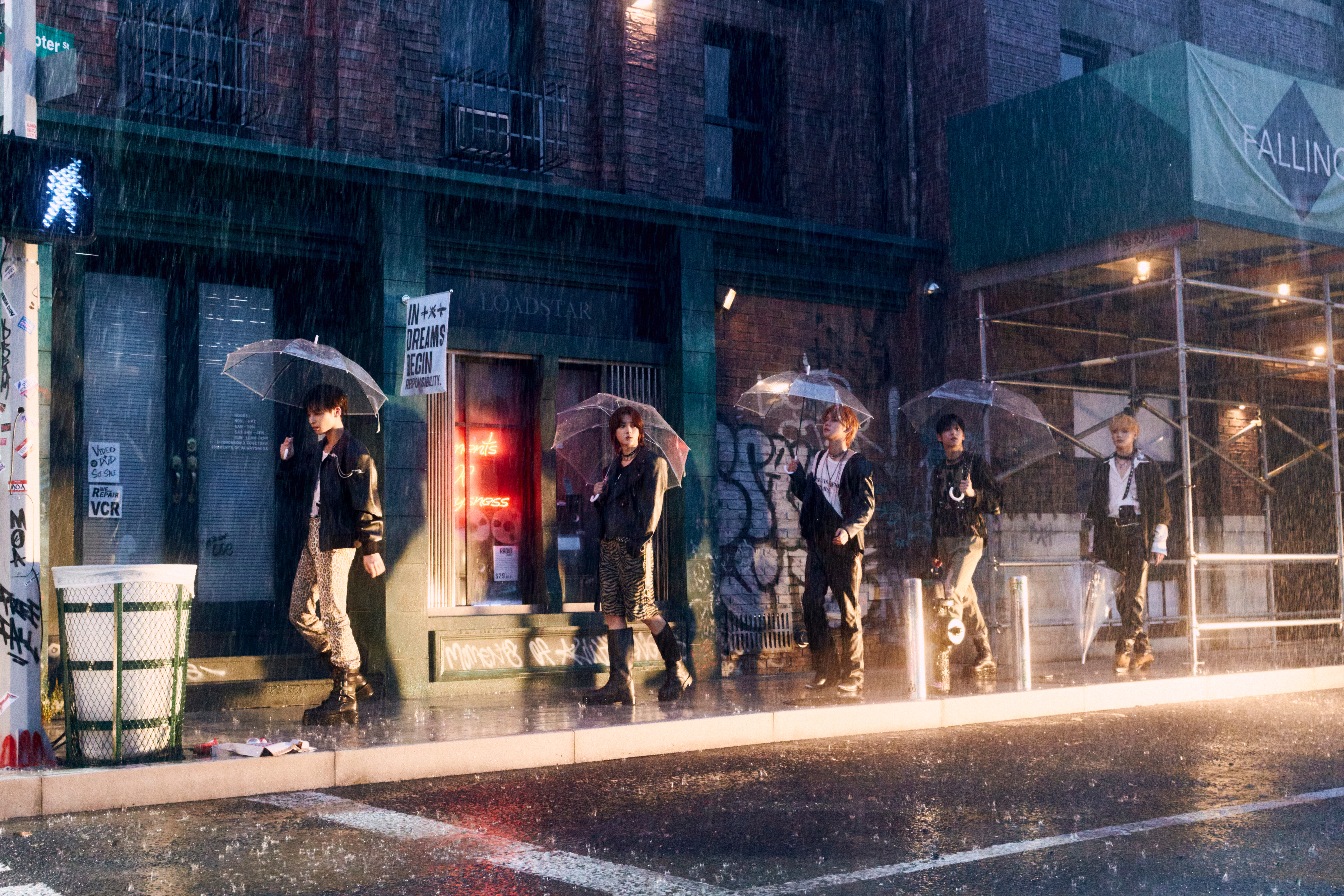 All five TXT members posing with umbrellas in the rain for REALITY concept photos.