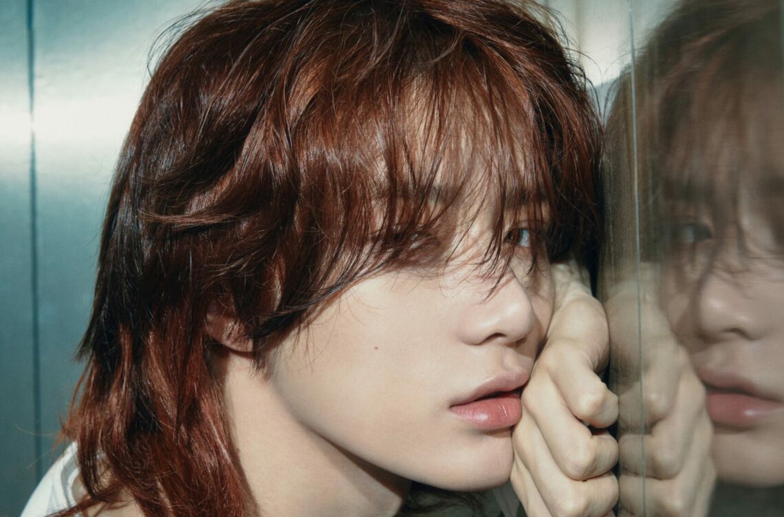Beomgyu posed against a reflective metal wall for MELANCHOLY concept photos.