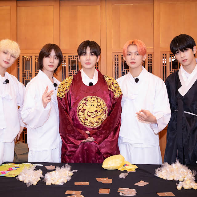 All five members of TXT posing to the camera after filming EP.119 of TODO